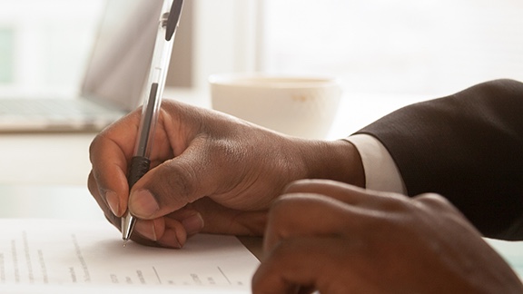 Person writing on paper