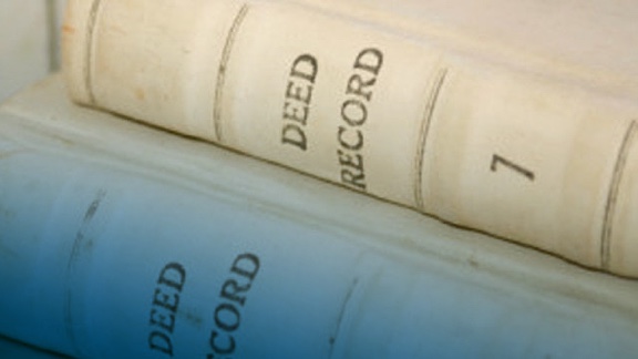 Two books that say Deed Record on the edge